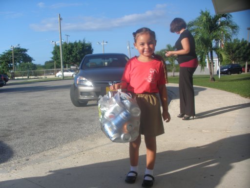 Girl dropping off soda cans